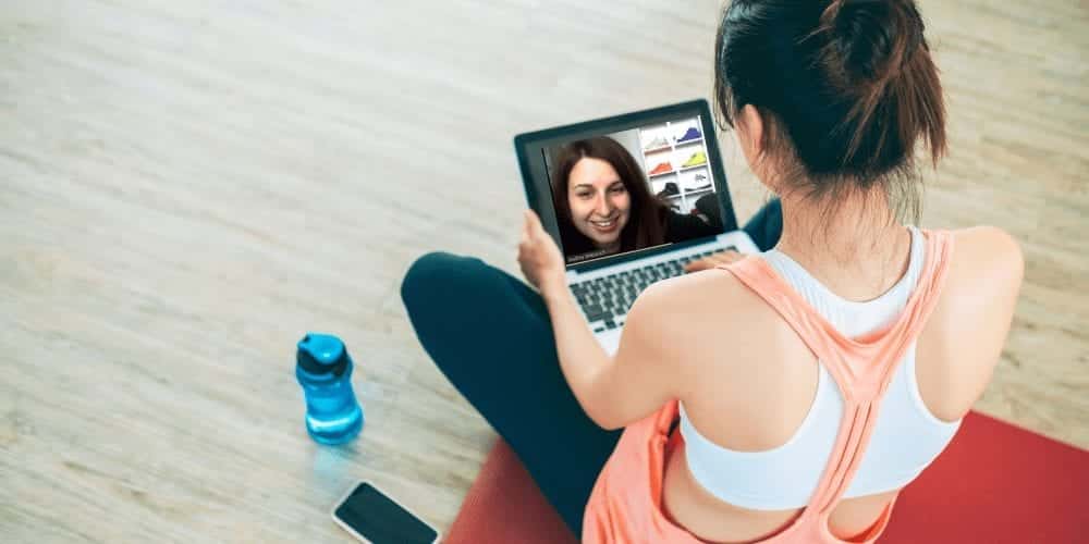 virtual personal trainer working with client in their home virtually