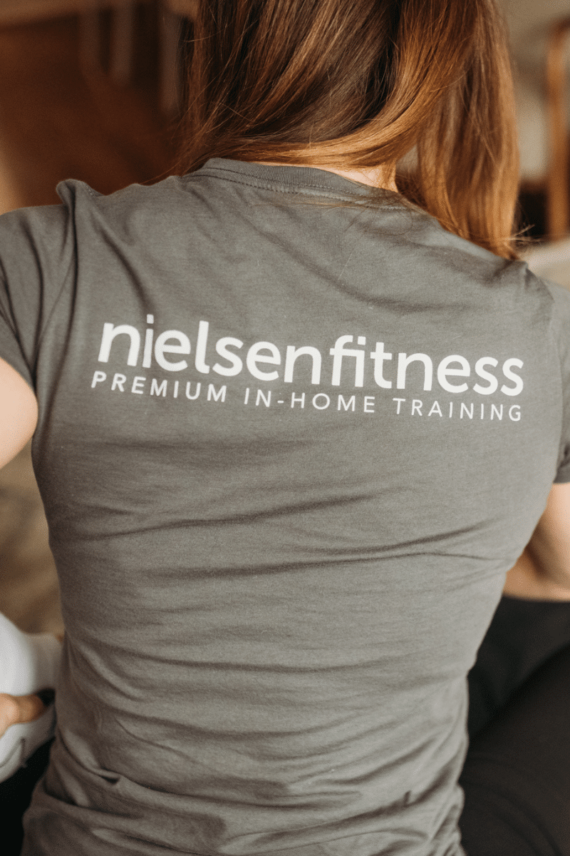 a trainer wears a Nielsen Fitness team shirt
