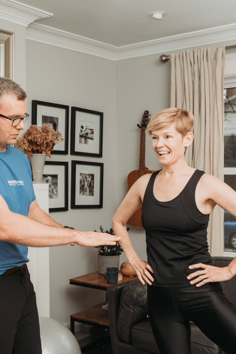 a trainer leads a client through a personal training movement screen