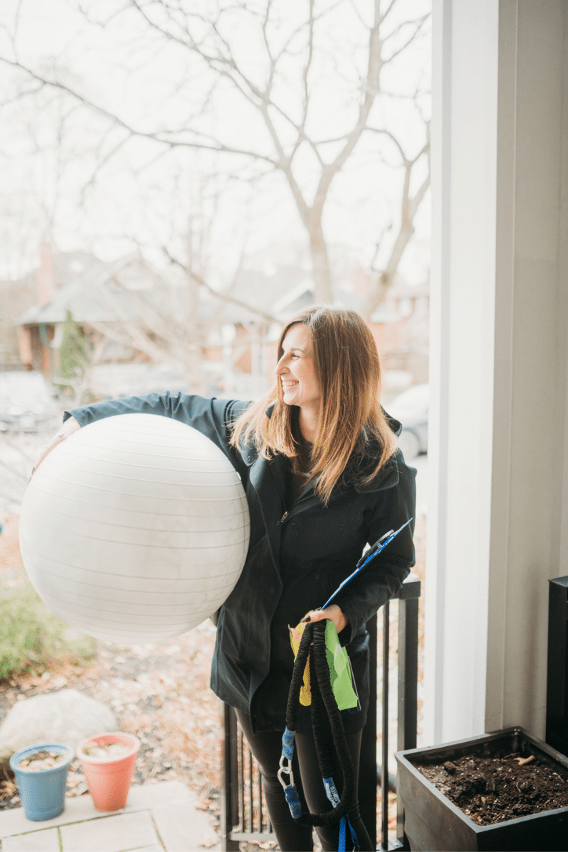 a trainer prepares for an in-home strength workout