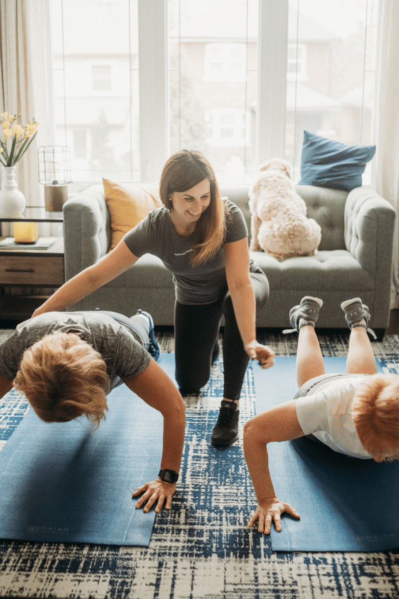 a trainer helps clients progress their strength training without weights