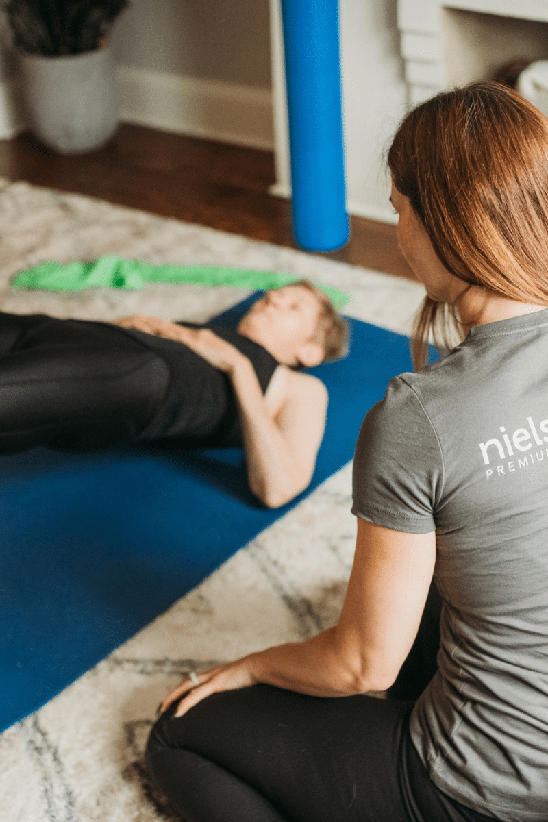 a trainer shows a client exercises for back pain