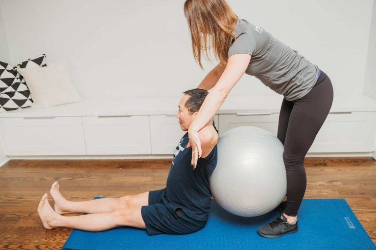 Personal trainer helping her student
